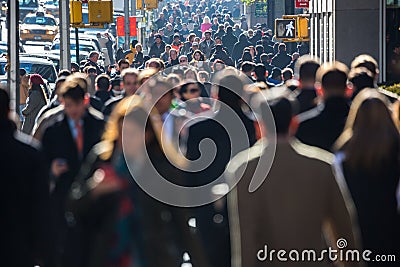 Crowd of people walking on street sidewalk