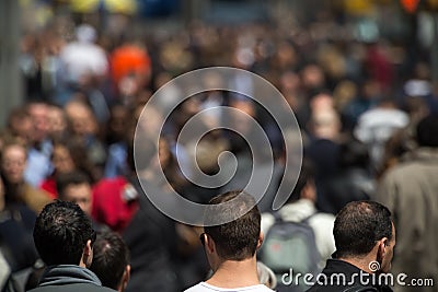 Crowd of people walking on street sidewalk