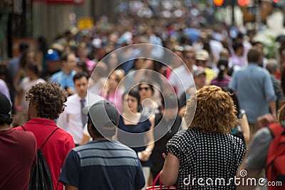 Crowd of people walking on street sidewalk