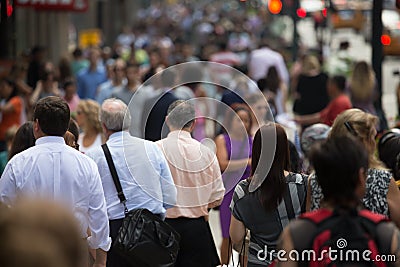 Crowd of people walking on street sidewalk