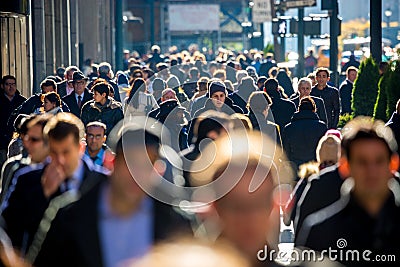 Crowd of people walking on street sidewalk