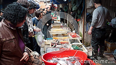 Crowded fish market stall, China