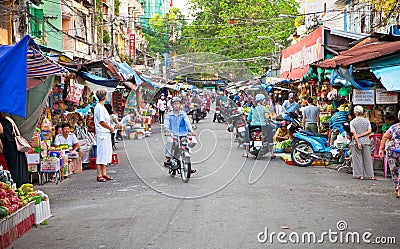 Crowded marketplace with street vendor in Ho Chi Minh City, Viet