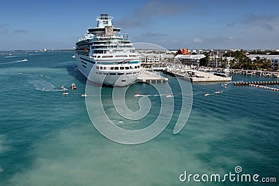 A cruise ship docked and anonymous people