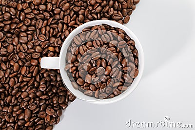 A cup of coffee beans on the edge of diagonal coffee beans shape