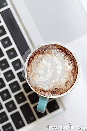 A cup of coffee on a laptop