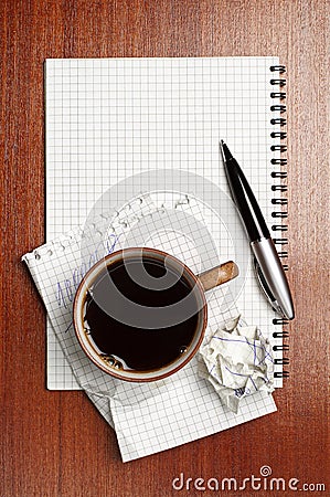 Cup of coffee, notebook and pen