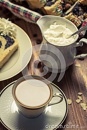 Cup of coffee, poppy seed cake and whipped cream