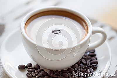 Cup of coffee on white table