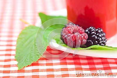 Cup of tea,raspberry and blackberry with leaves