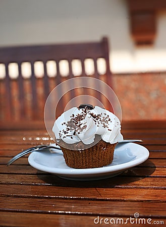 Cupcake with cream and chocolate shavings