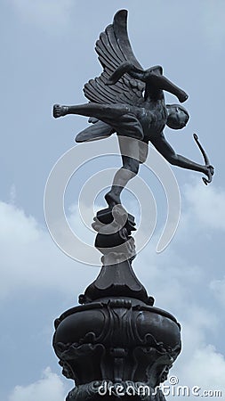 Cupid Statue In Blue Sky