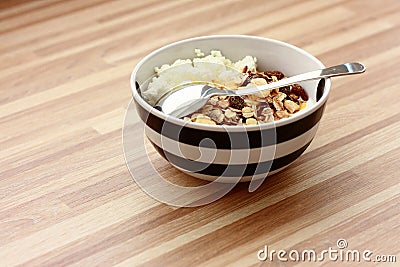 Curd cheese with muesli and spoon
