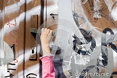 Curiosity of little girl - hand and door