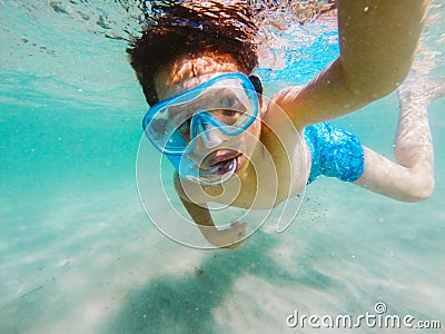 Curious boy exploring underwater