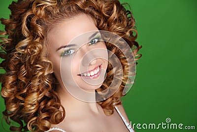 Curly Hair. Attractive smiling woman portrait