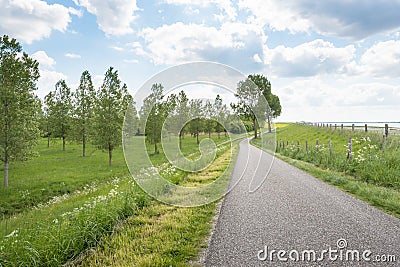 Curved country road along a Dutch dike
