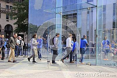 Customers line up outside of the Apple Store on Fifth Avenue to buy the new iPhone 6