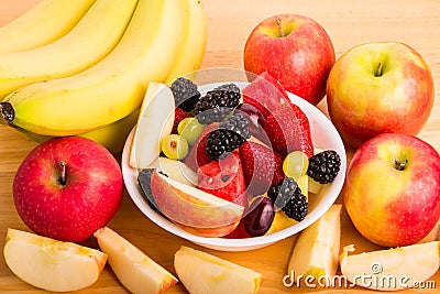 Cut Fruit in Bowl with Bananas and Whole and Cut Apples