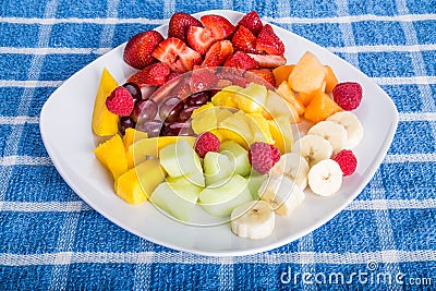 Cut and Sliced Fruit on a Square White Plate