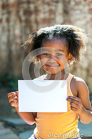 Cute african girl holding white blank card.
