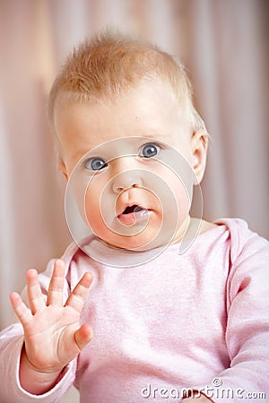 Cute baby girl waving hello/goodbye