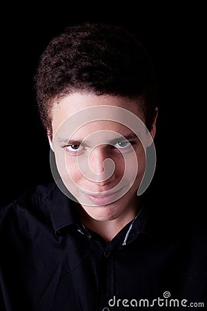 Cute boy, smiling and looking to camera on black