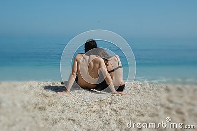 A cute couple cuddles on an italian beach