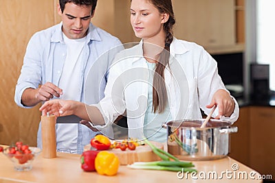 Cute couple using a tablet computer to cook
