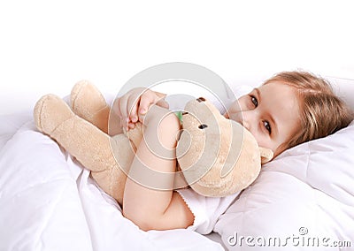 Cute girl cuddling with teddy bear