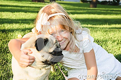 Cute girl hugging with lovely dog at the park