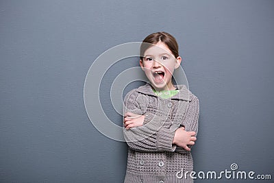 Cute girl laughing with arms crossed