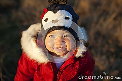 Cute girl in penguin hat smiling