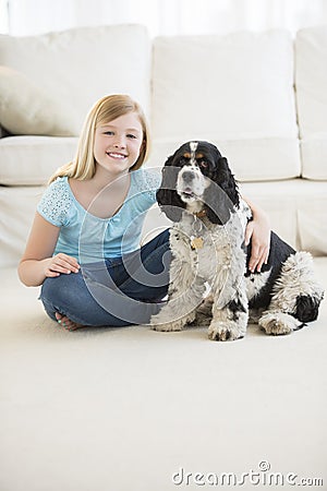 Cute Girl Sitting With Pet Dog In Living Room