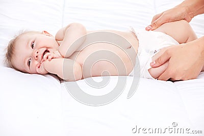 Cute infant lying on white bed