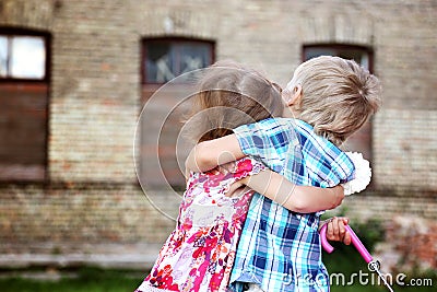 Cute little boy and girl hug