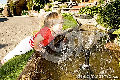 Cute little girl near a fountain