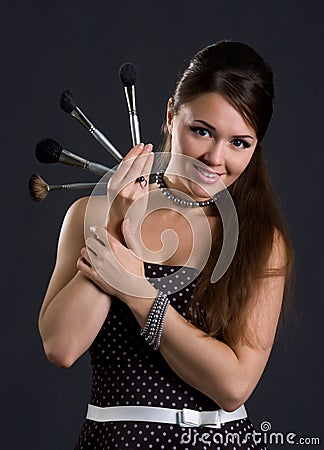 Cute makeup artist with brushes
