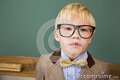 Cute pupil dressed up as teacher in classroom