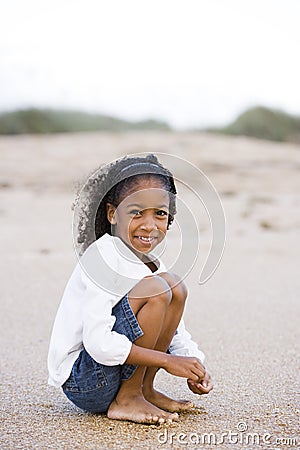 Cute six year old African-American girl on sand
