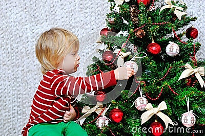 Cute toddler decorating Christmas tree