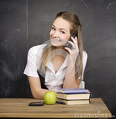 Cute young student near blackboard with copy book calculator pen, copy space