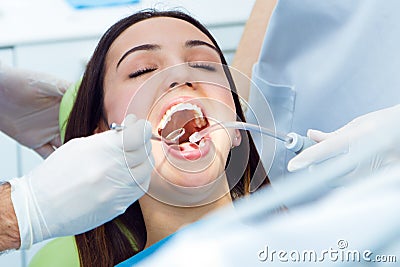 Cute young woman at the dentist. Mouth checkup