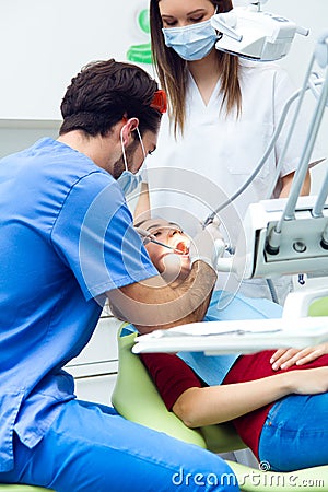 Cute young woman at the dentist. Mouth checkup