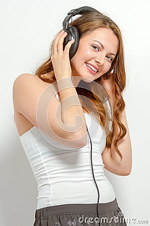 Cute young woman listens to headphones