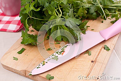 Cutting board with knife and parsley chopping