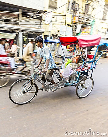 Cycle rickshaw transports passenger in Delhi, India