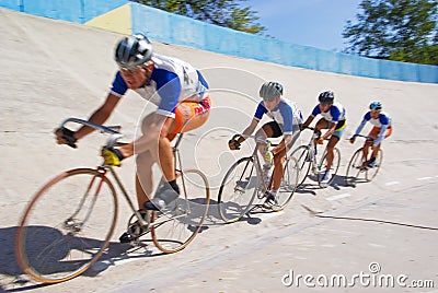 Cycling team fast racing on velodrome