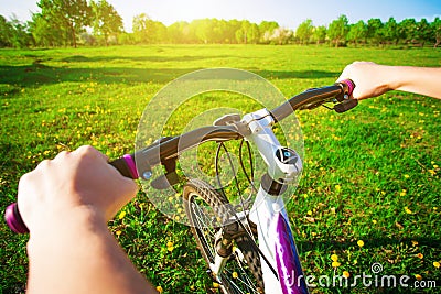 Cyclist in a green field on a bike. travel