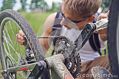 Cyclist man checks chain